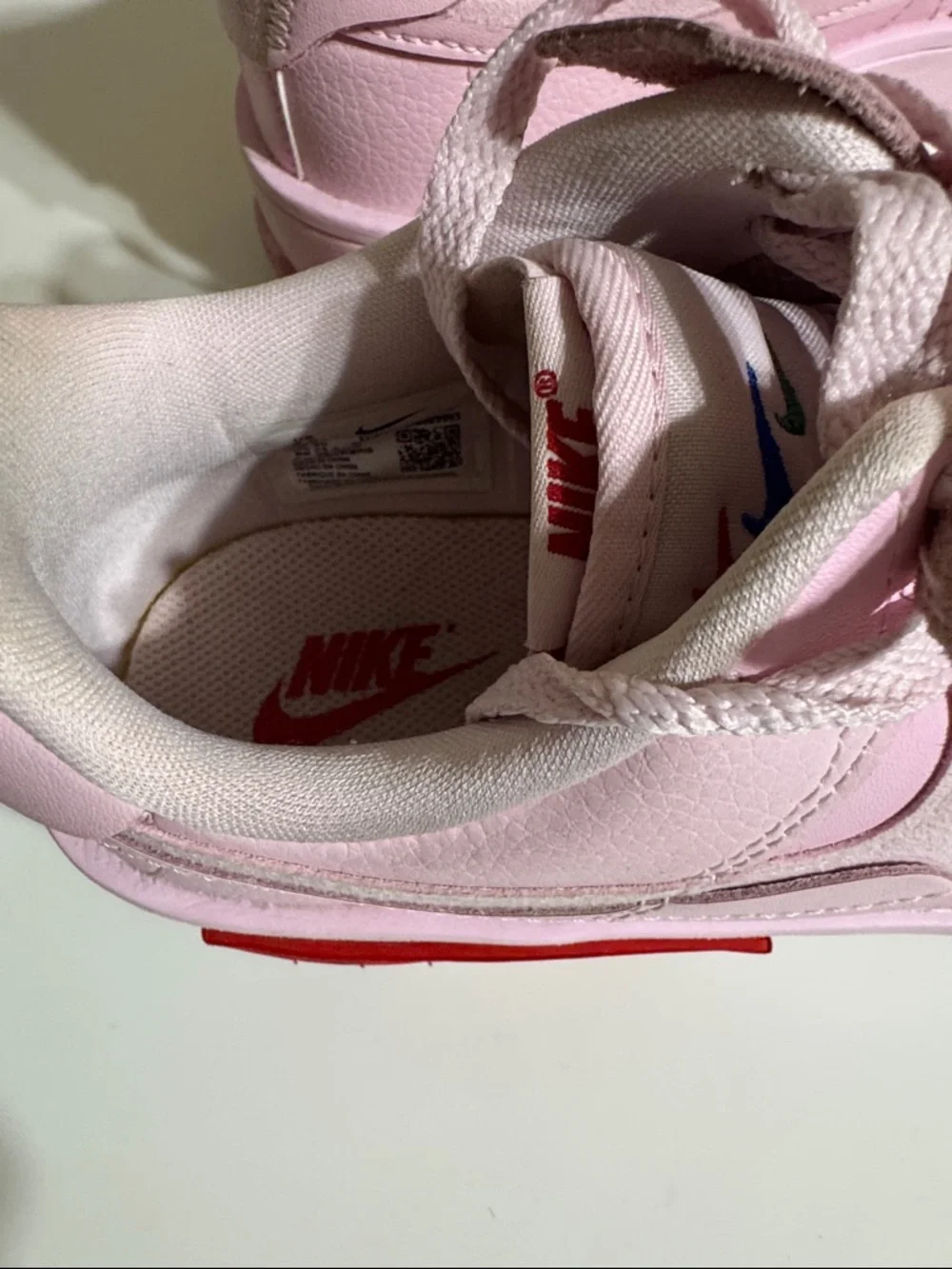 Nike Women’s Pink Low-Top Sneakers with Red Accent